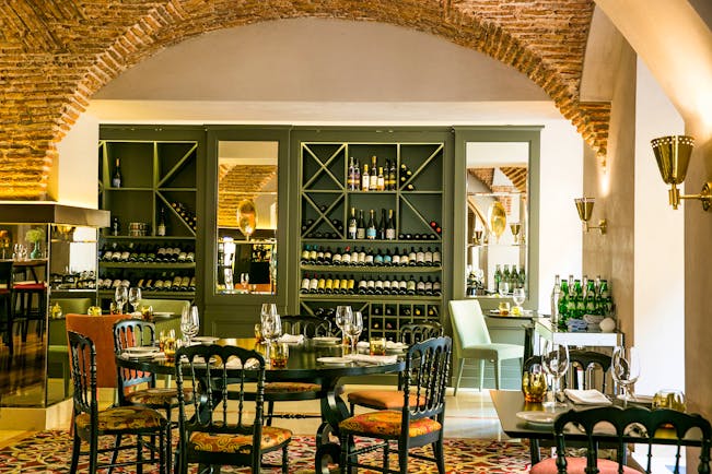 Pousada de Lisboa restaurant, arched ceilings in brown bricks, tables and chairs, large wine cupboard