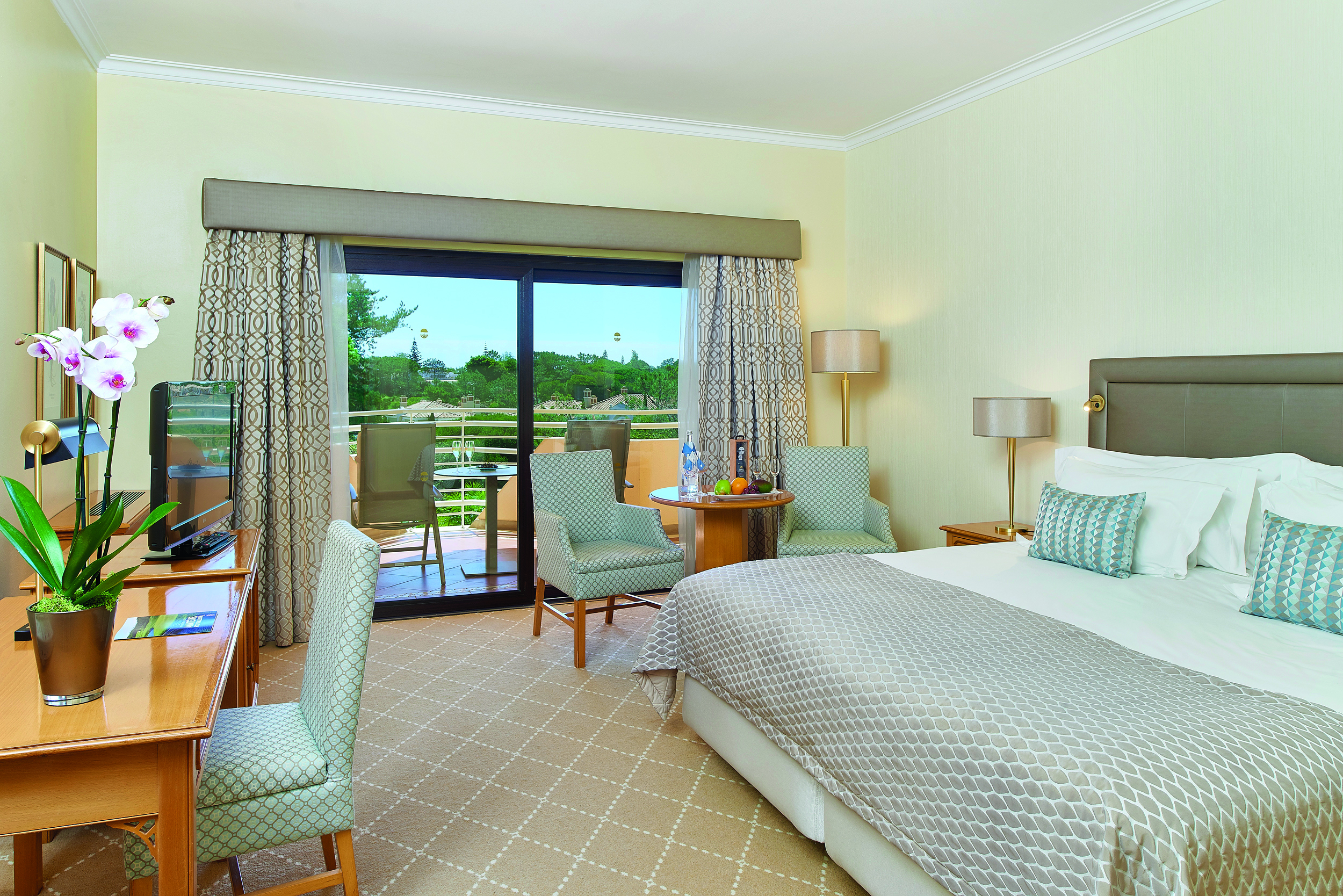 Quinta do Lago Portugal bedroom with desk and patio doors to balcony with sun loungers 