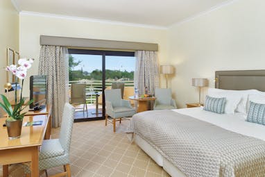 Quinta do Lago Portugal bedroom with desk and patio doors to balcony with sun loungers 