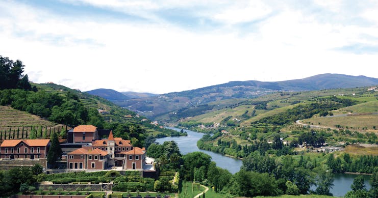 Six Senses Douro Valley Portugal aerial panorama of complex of buildings in a valley next to a river
