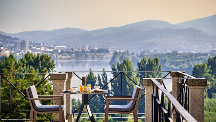 Six Senses Douro Valley Portugal balcony breakfast dining area overlooking water and town