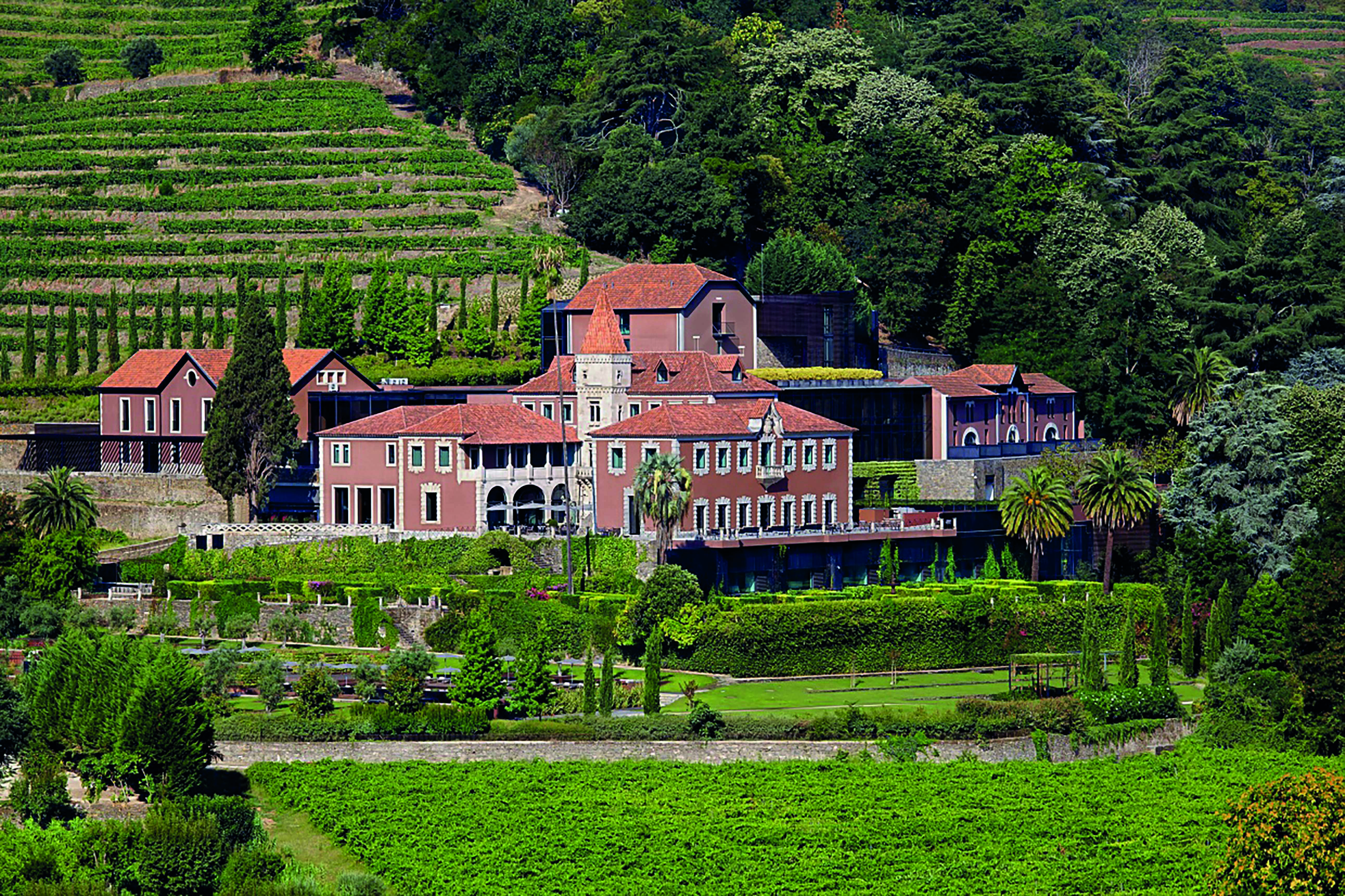 Six Senses Douro Valley Portugal exterior aerial view of a complex of buildings on a wooded hill
