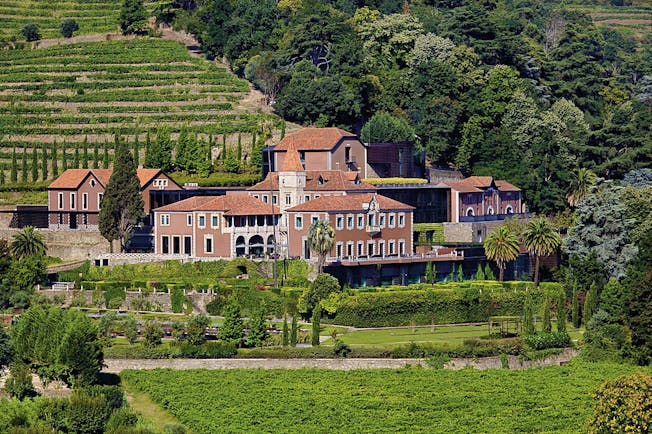 Six Senses Douro Valley Portugal exterior aerial view of a complex of buildings on a wooded hill