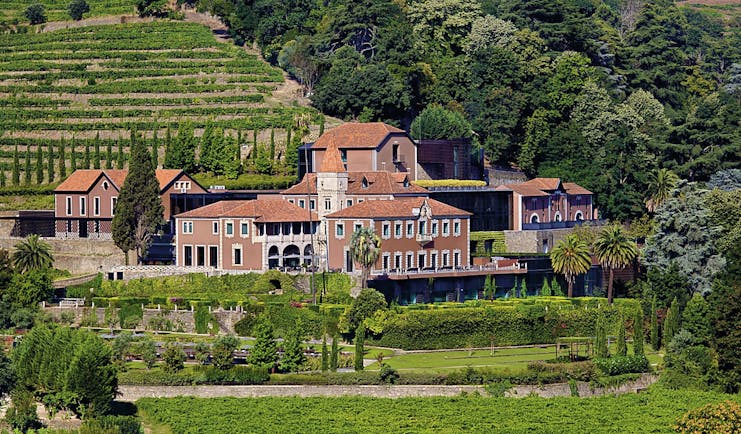 Six Senses Douro Valley Portugal exterior aerial view of a complex of buildings on a wooded hill