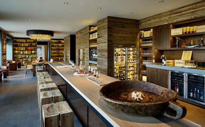 Six Senses Douro Valley Portugal wine library bar area with wine fridges and wooden stools
