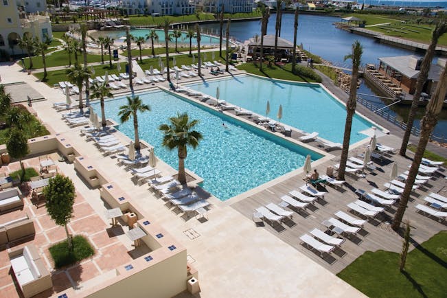The Lake Spa aerial shot of pools, sun loungers, umbrellas, palm trees