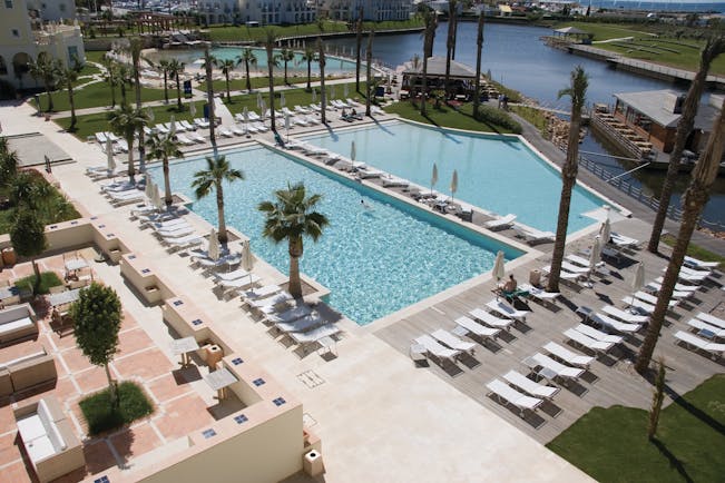 The Lake Spa aerial shot of pools, sun loungers, umbrellas, palm trees