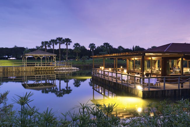 The Lake Spa restaurant building and decking over pond, tables and chairs, 