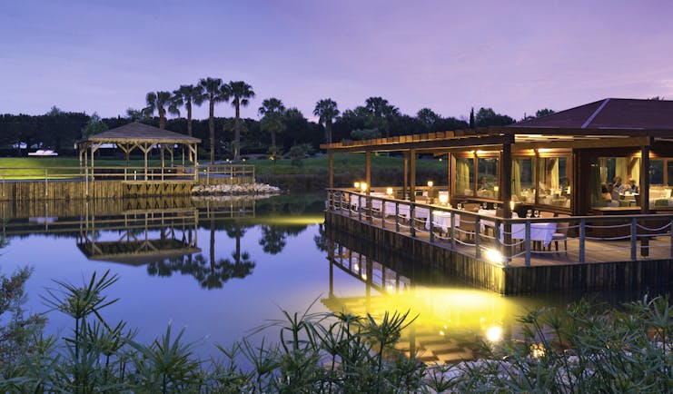 The Lake Spa restaurant building and decking over pond, tables and chairs, 