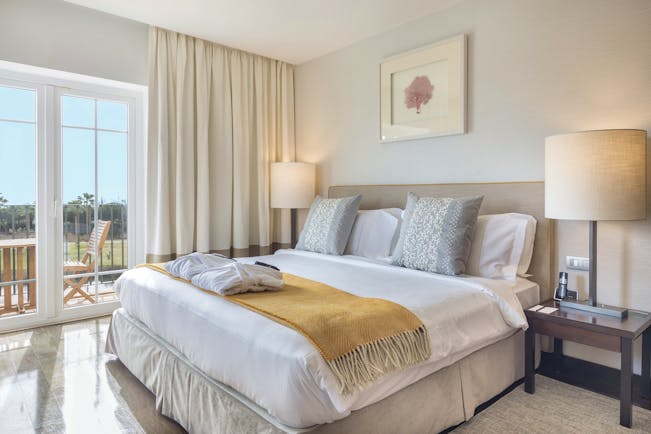 The Lake Spa suite bedroom, double bed, bright modern decor, private balcony