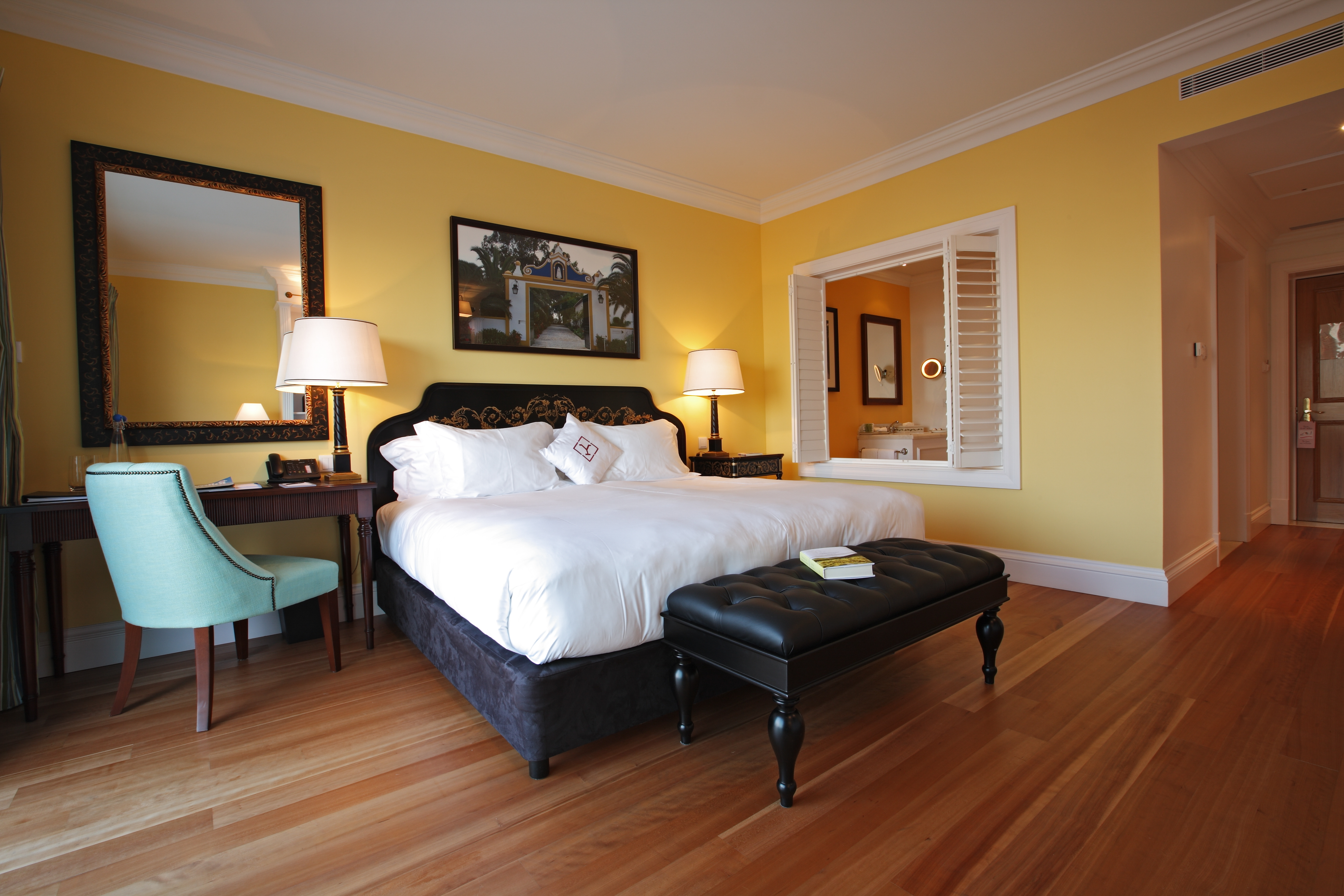 Yeatman Portugal bedorom with yellow walls and blue chair