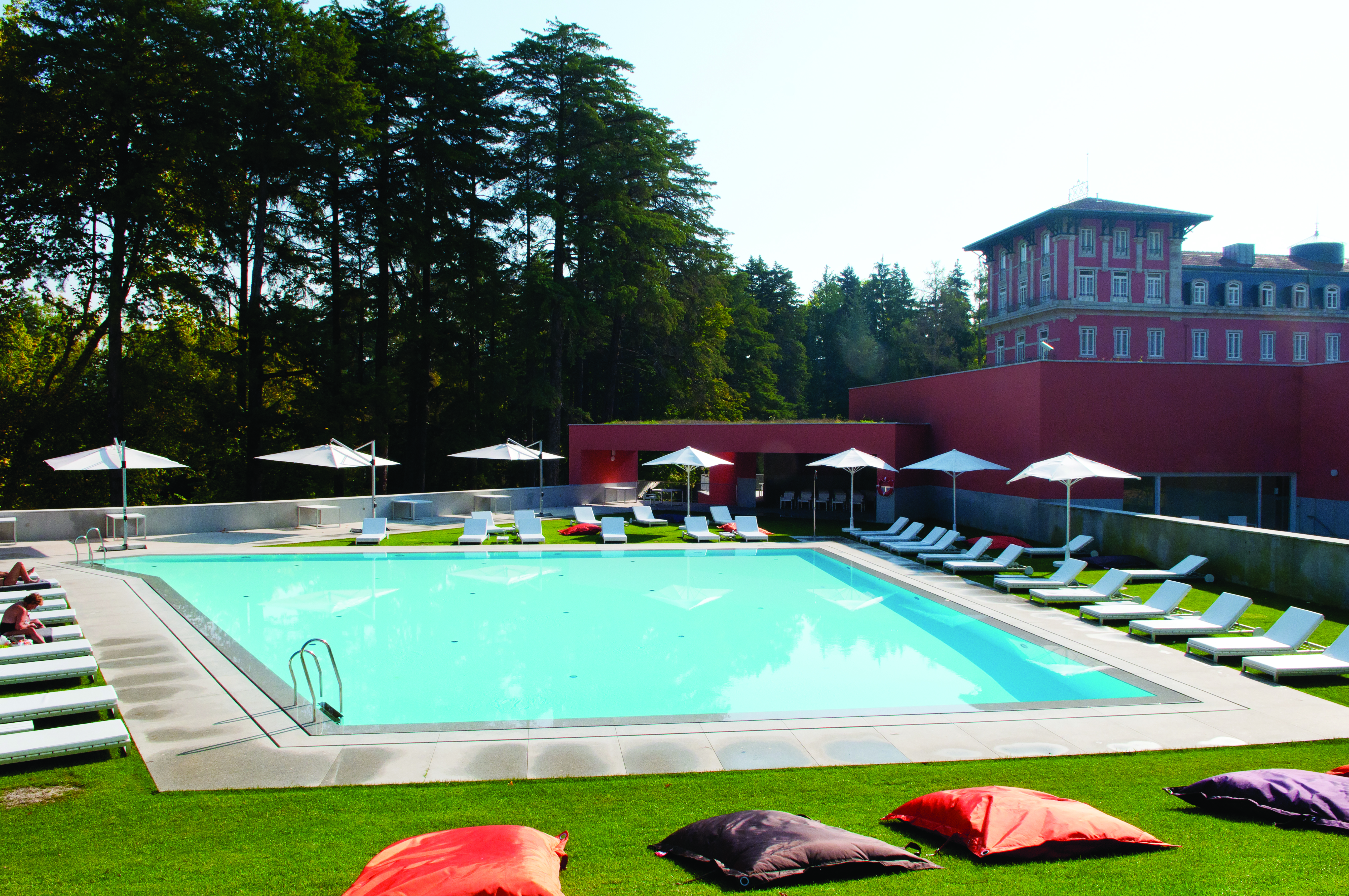 Vidago Palace Portugal exterior large pink building with fountain in front and steps leading to it