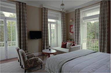 Vidago Palace Portugal privilege bedroom with seating area and balcony