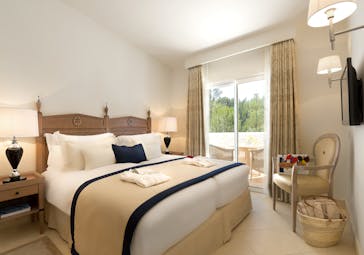 Vila Vita Parc Portugal Oasis family suite bedroom with chair and terrace