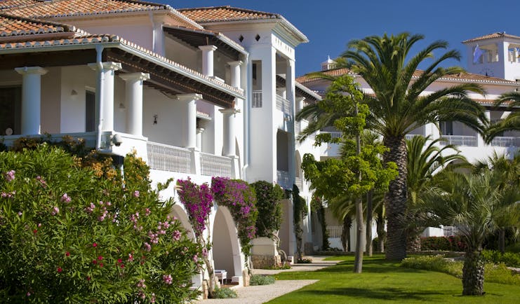 Vila Vita Parc Portugal exterior white villa with arches and balconies pink flowers and trees
