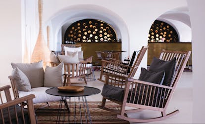 Lounge at the vilalara thalassa resort with wooden chairs and a grey and cream colour scheme
