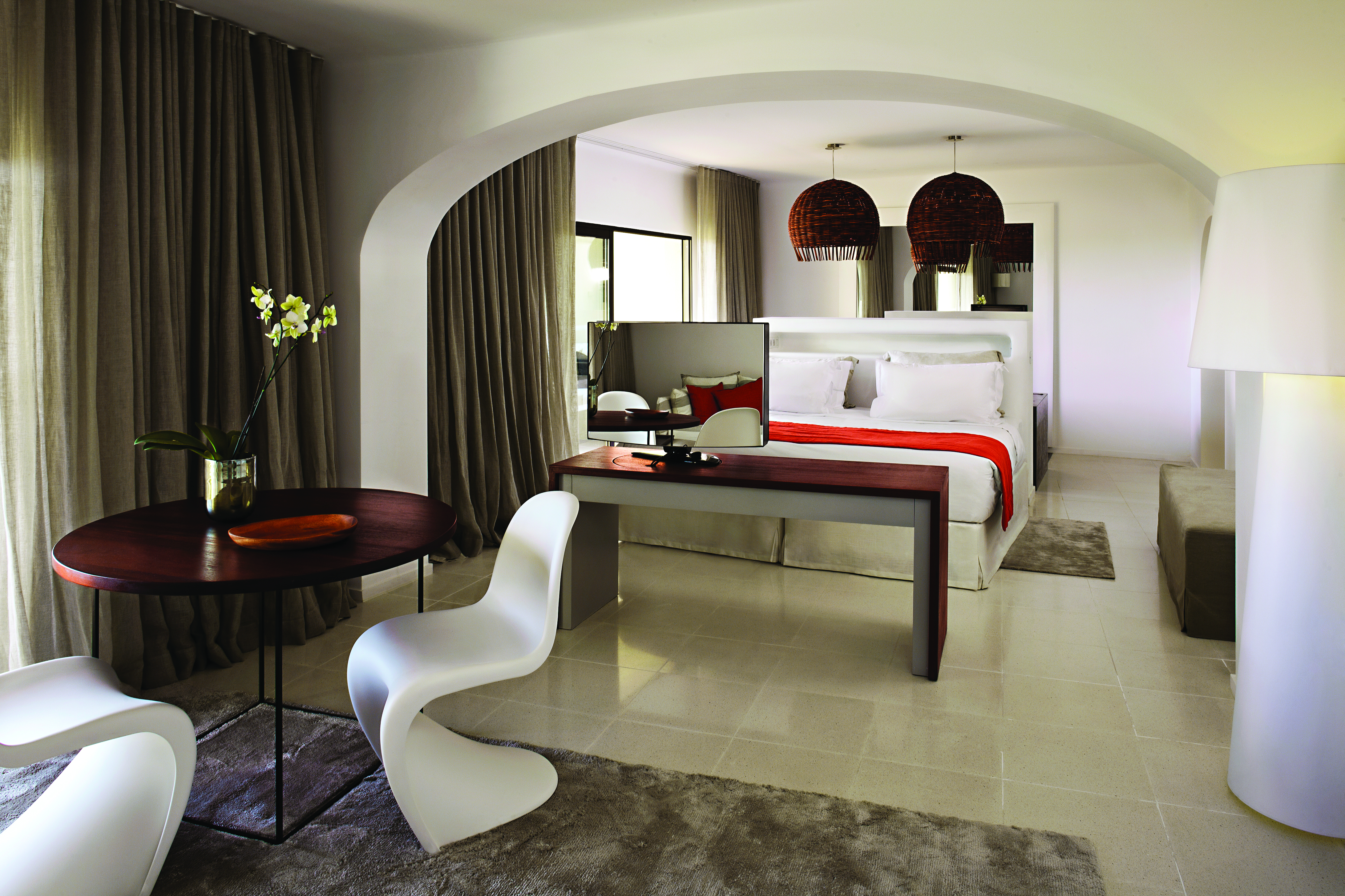 Suite at the vilalara thalassa resort in portugal with a grey and white colour scheme, large double bed and chairs