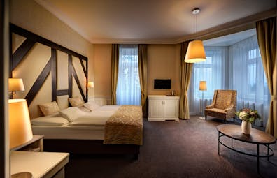 Grandhotel Stary Smokovec standard room, large bed, table armchair, comfortable decor