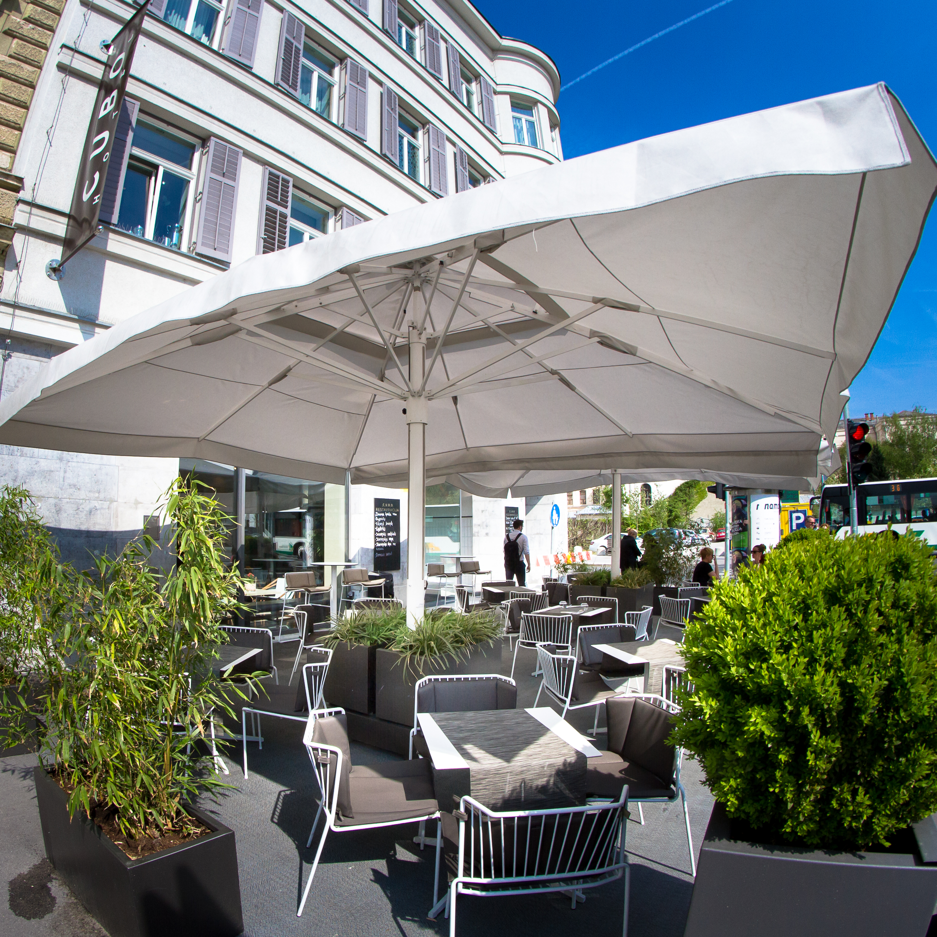 Hotel Cubo terrace, outddor dining area, tables and chairs shaded by umbrellas