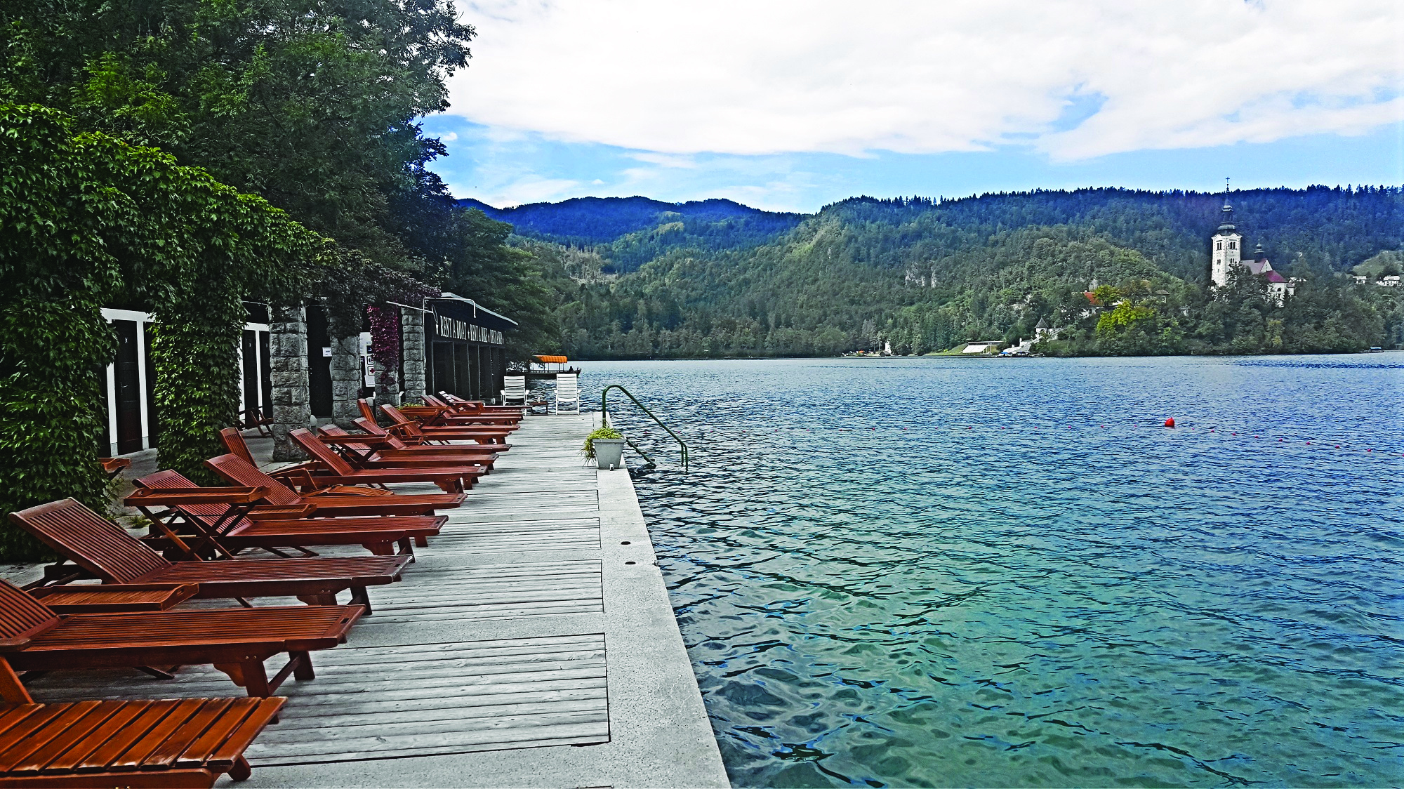 Sitting area with wooden deckchairs by the lake 