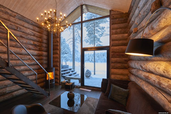 Arctic Retreat cabin interior, sofa, timber walls, modern light fitting 