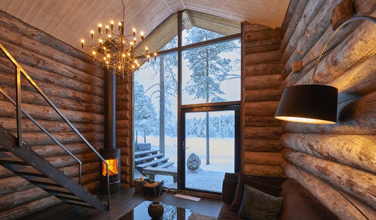 Arctic Retreat cabin interior, sofa, timber walls, modern light fitting 