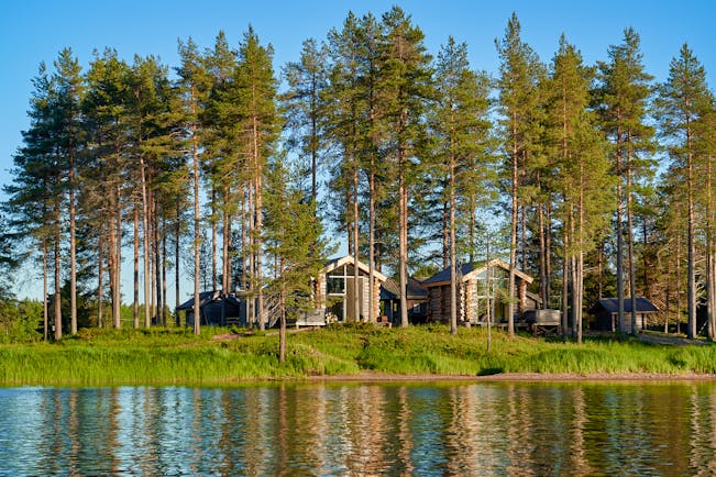 Arctic Retreat cabins overlooking the river, woodland, blue sky