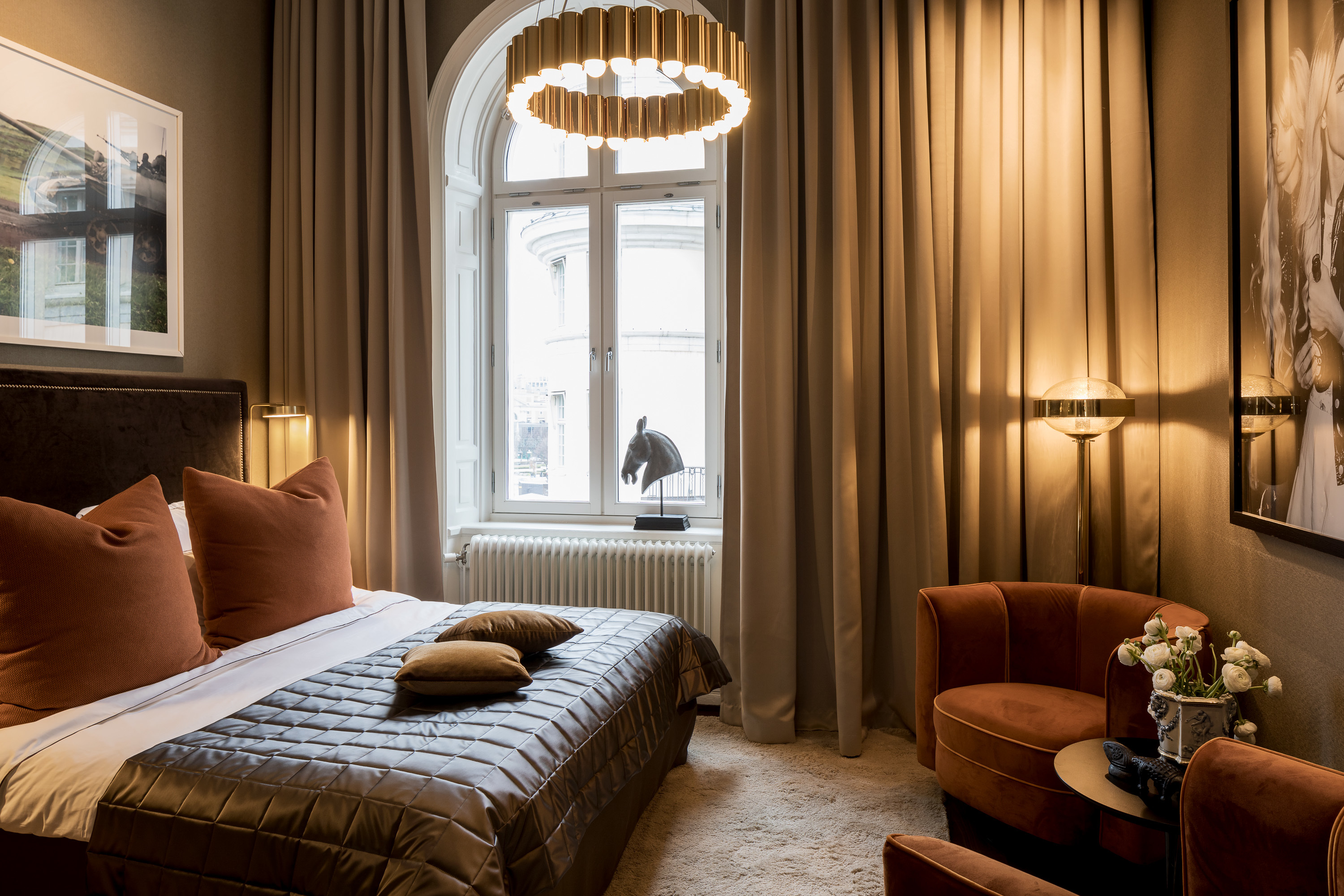 Hotel Lydmar classic king room, bed, long curtains, velvet tub chairs, cosy decor