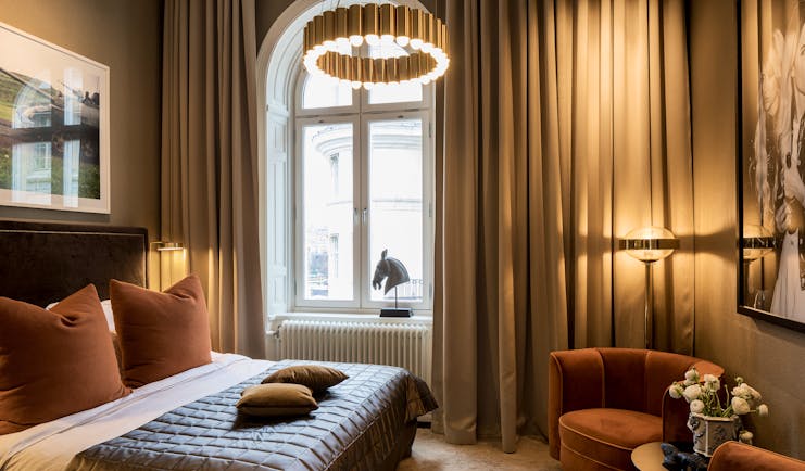 Hotel Lydmar classic king room, bed, long curtains, velvet tub chairs, cosy decor