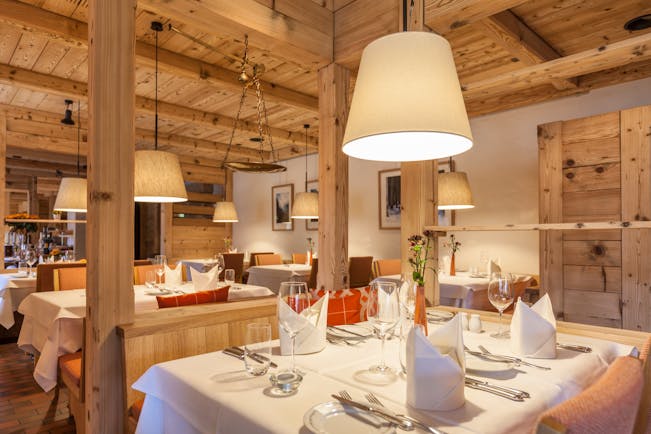 Gstaaderhof pale wooden walls and ceiling in restaurant with white table cloths