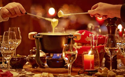 Gstaaderhof eating a cheese fondue by candlelight