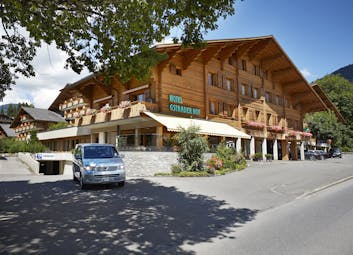 Gstaaderhof wooden chalet modern building with car outside
