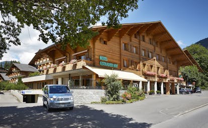 Gstaaderhof wooden chalet modern building with car outside
