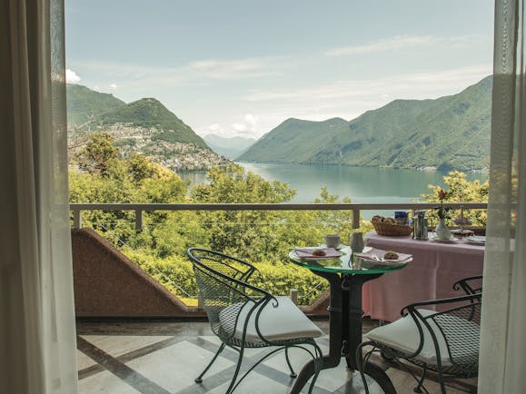Villa Principe Leopoldo balcony with table and chairs overlooking lake and mountains