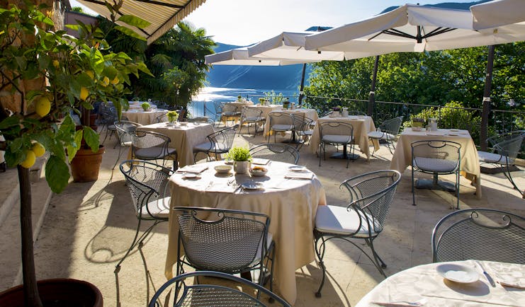 Villa Principe Leopoldo outdoor seating on terrace with sunshades and lake views
