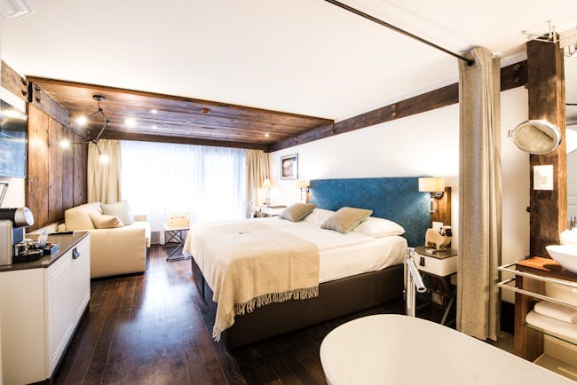 Hotel Alpenhof Zermatt large white and brown room with open bathroom