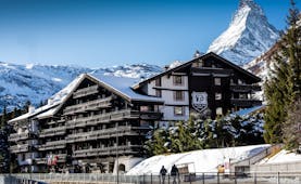 Hotel Alpenhof Zermatt outside of wooden chalet hotel in the snow with Matterhorn mountain behind