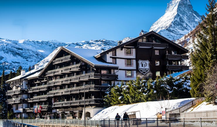 Hotel Alpenhof Zermatt outside of wooden chalet hotel in the snow with Matterhorn mountain behind
