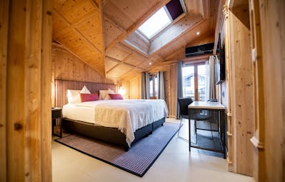 Romantik Hotel Julen Zermatt large room with light wood on walls and skylight plus window to balcony