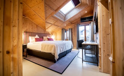 Romantik Hotel Julen Zermatt large room with light wood on walls and skylight plus window to balcony