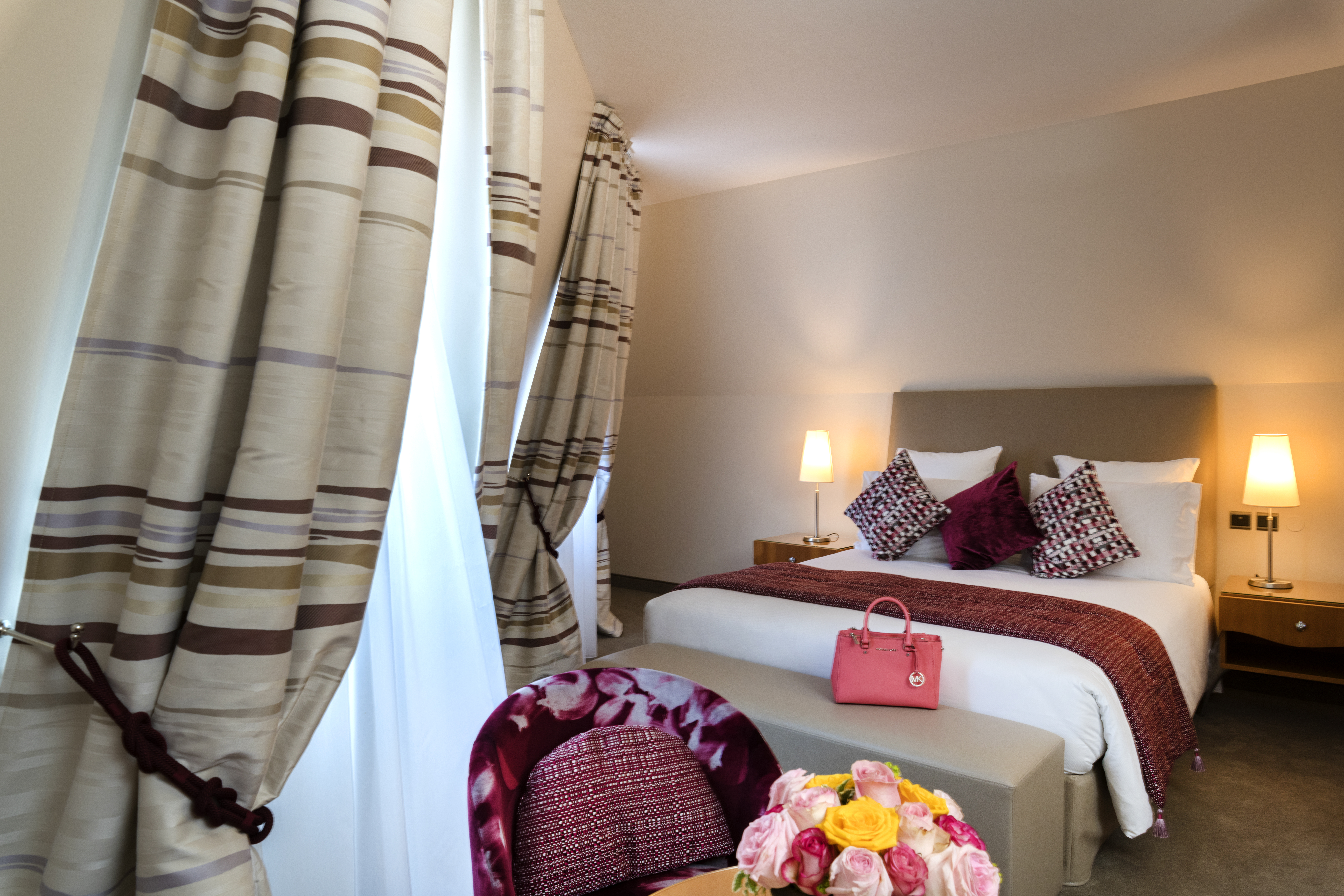 Regent petite france classic room with red throw and bowl of roses