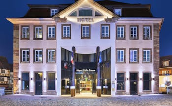 Front of Regent petite france at night with pink coloured stone