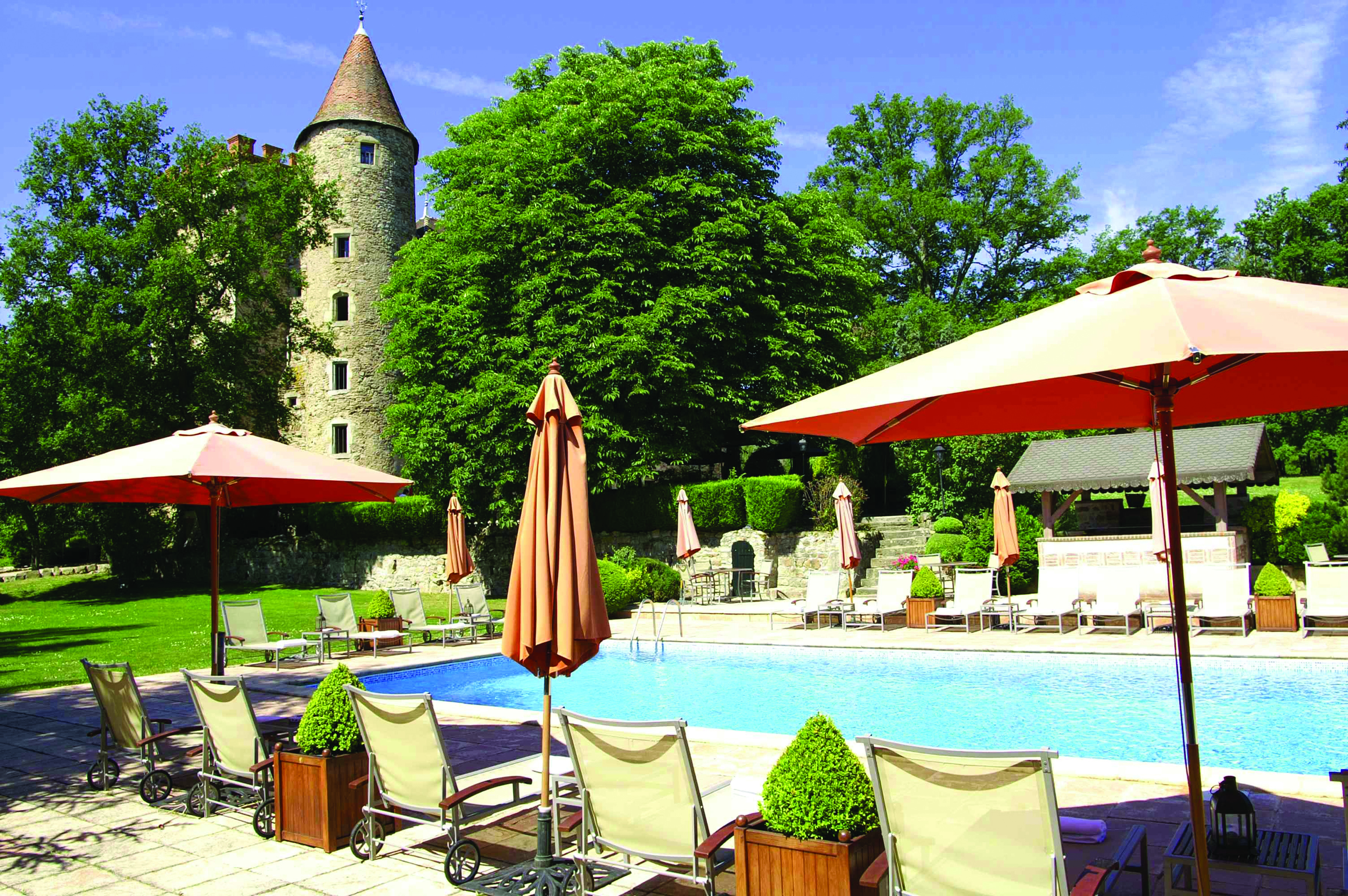 Chateau Codignat Auvergne outdoor pool with loungers surrounded by trees