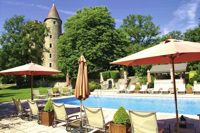 Chateau Codignat Auvergne outdoor pool with loungers surrounded by trees