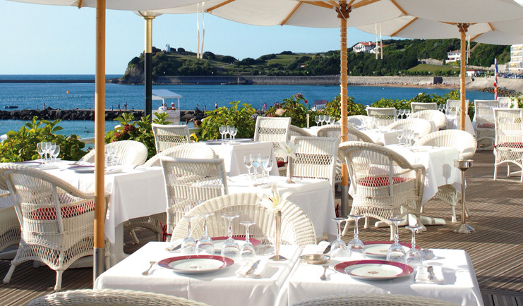 Grand Hotel Basque Country Terasse Rosewood outdoor dining area with umbrellas and sea view