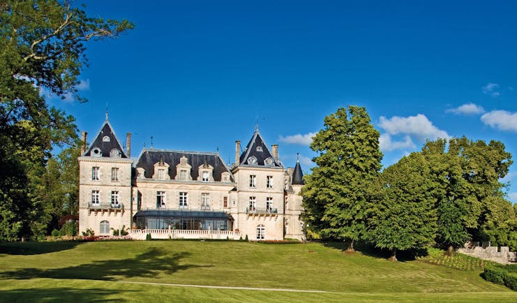 Chateau de Mirambeau exterior, grand hotel building, traditional chateau architecture, grass lawn, trees