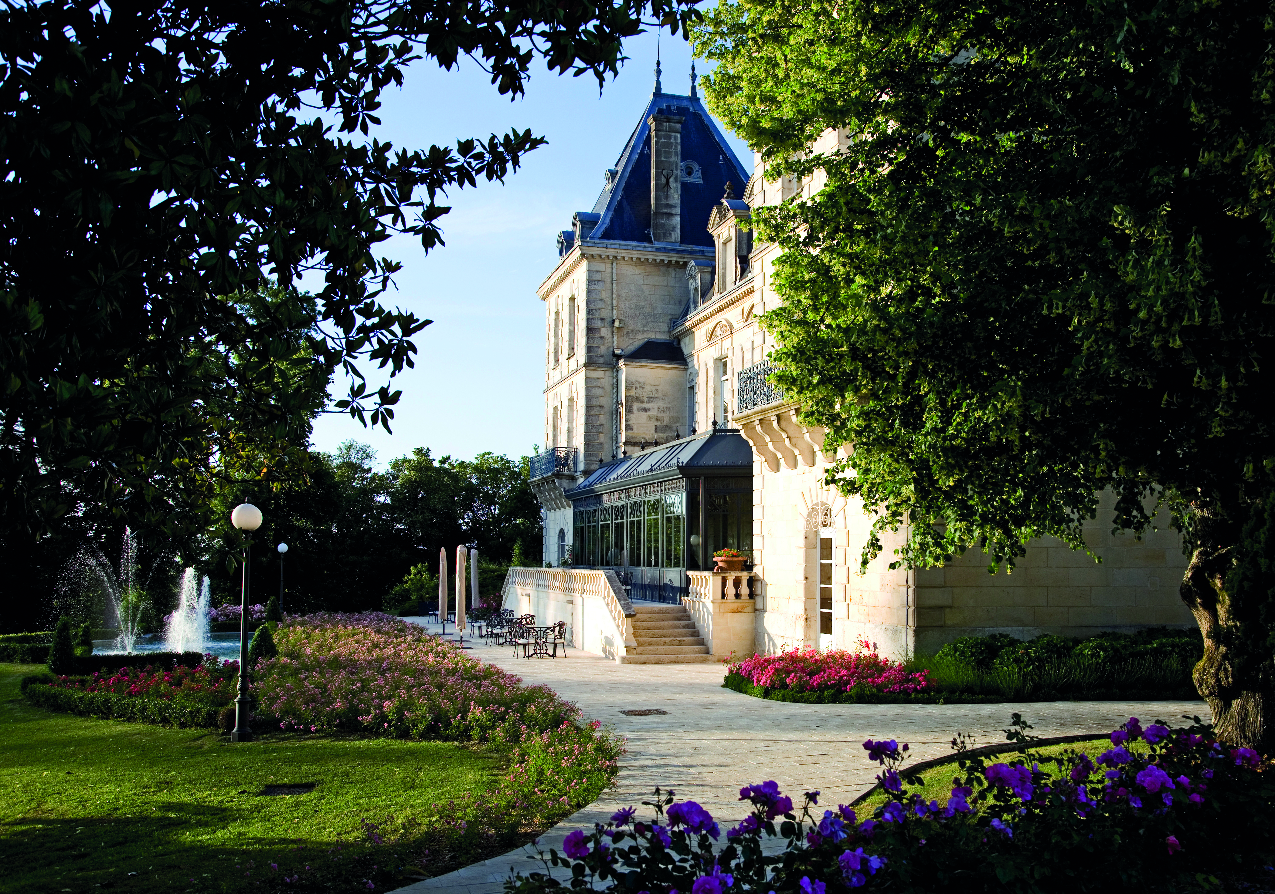 Entrance to hotel through drive way showing driveway and stairs leading up to hotel