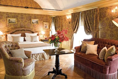 Chateau de Mirambeau suite, double bed, sofa, armchair, draped curtains, grand traditional decor