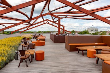 Roof terrace with wooden deck and low chairs Chais Monnet Cognac