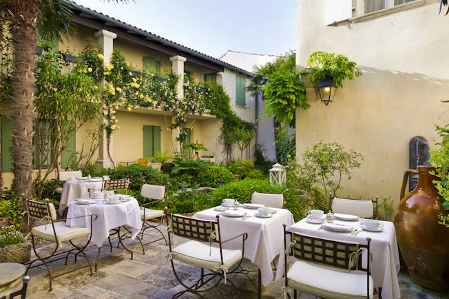 Hotel de Toiras shady terrace with dining chairs and tables